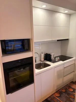 a kitchen with a microwave oven and a sink at Stupine Relax Suite TUZLA in Tuzla