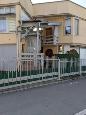 a white fence in front of a house at Apartman D Ibukic in Bihać