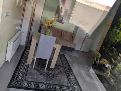 a living room with a couch and a table at Apartman D Ibukic in Bihać