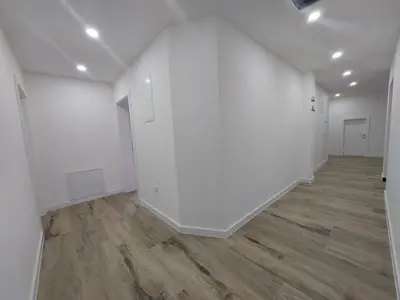 an empty room with white walls and wood floors at Apartmani Vidović in Prozor