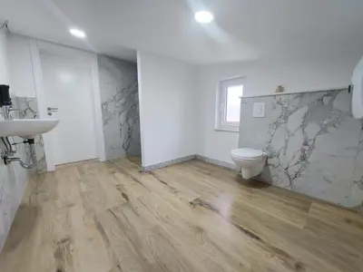 a bathroom with a toilet and a sink at Apartmani Vidović in Prozor