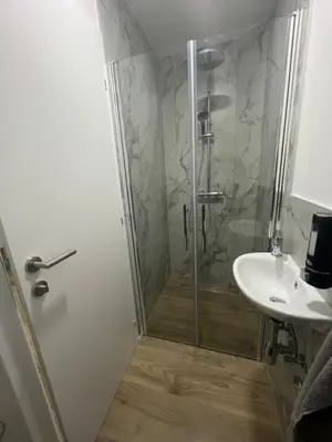 a bathroom with a shower and a sink at Apartmani Vidović in Prozor