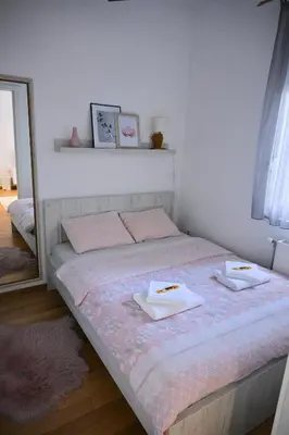 a bedroom with a bed with two dishes on it at Apartman Nika in Banja Luka
