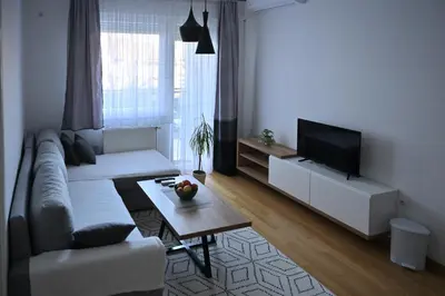 a living room with a couch and a tv at Apartman Nika in Banja Luka