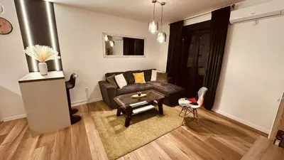 a living room with a couch and a table at Premium Skver Tuzla - City Center in Tuzla