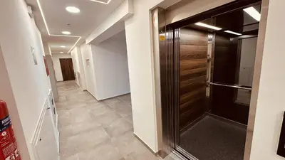 a hallway with a sliding door in a house at Premium Skver Tuzla - City Center in Tuzla