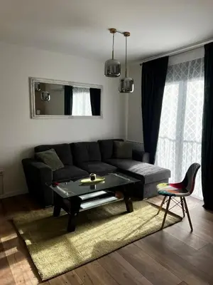 a living room with a couch and a table at Premium Skver Tuzla - City Center in Tuzla
