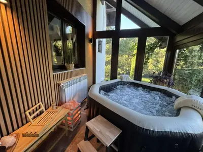 a large bath tub in a room with a window at Residence Green Pool & SPA in Visoko