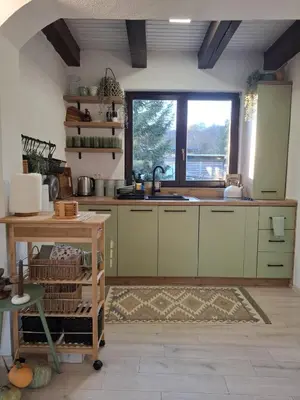 a kitchen with green cabinets and a sink and a window at Residence Green Pool & SPA in Visoko