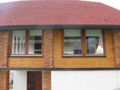 a man looking out the window of a house at Holiday Home Slavica in Kupres