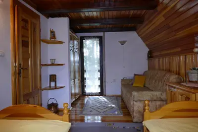 a living room with a couch and a living room with at Apartman Sani in Vlasic