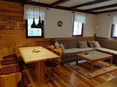 a living room with a couch and a table at Apartman Sani in Vlasic