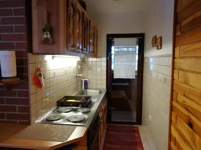 a kitchen with a stove and a sink at Apartman Sani in Vlasic
