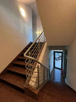 a staircase with a metal railing in a building at Motel Papić in Tomislavgrad