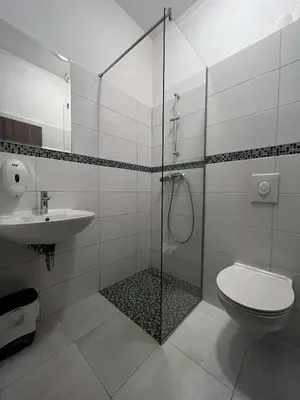 a bathroom with a shower and a toilet and a sink at Motel Papić in Tomislavgrad