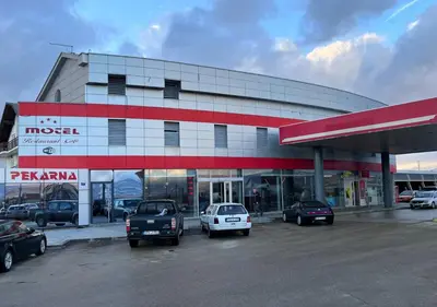 a gas station with cars parked in a parking lot at Motel Papić in Tomislavgrad
