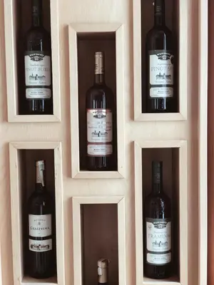 four bottles of wine are in a wooden box at Hotel Kupres in Kupres