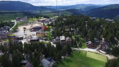an aerial view of a town with trees and buildings at Vlašić House in Vlasic