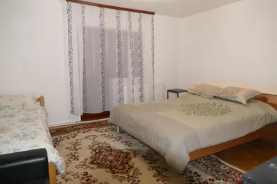 a bedroom with a bed and a window with curtains at Vlašić House in Vlasic