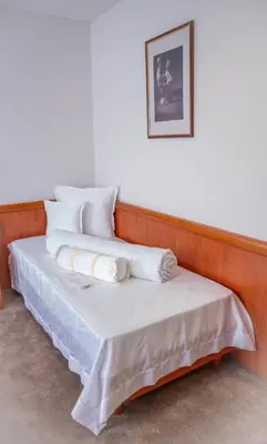 two beds with pillows on them in a room at Hotel Integra in Doboj