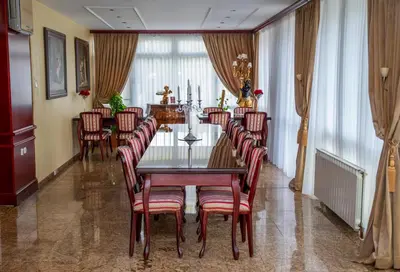 a dining room with a table and chairs at Hotel Integra in Doboj