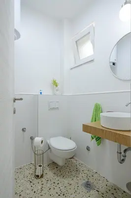 a white bathroom with a toilet and a sink at Piramida Visoko in Visoko