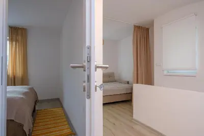 a room with a bedroom with a bed and a window at Piramida Visoko in Visoko