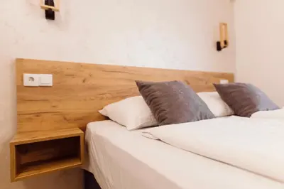 two beds sitting next to each other in a room at Guest House Babilon in Prijedor