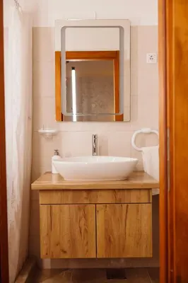 a bathroom with a sink and a mirror at Guest House Babilon in Prijedor