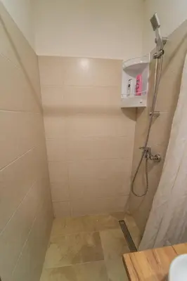 a bathroom with a shower with a shower curtain at Guest House Babilon in Prijedor