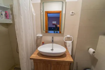 a bathroom with a white sink and a mirror at Guest House Babilon in Prijedor