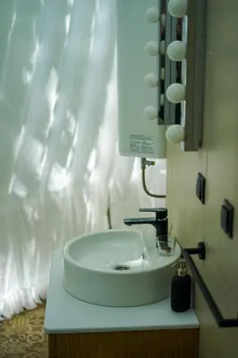 a bathroom with a white sink and a mirror at Japodski otoci in Račić