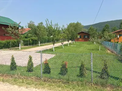 a fence with christmas trees in a yard at Villa Giulia in Bihać