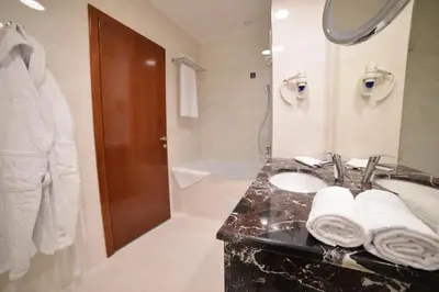 a bathroom with a sink and a shower at Hotel Mellain in Tuzla
