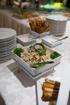 a table with a plate of food on a table at Hotel Mellain in Tuzla