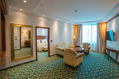 a hotel room with a large mirror and a bedroom at Hotel Mellain in Tuzla