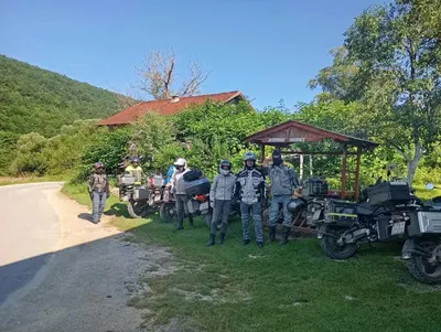 a group of people standing in the grass next to their motorcycles at Home-Vasva and Hazim in Ćukovi