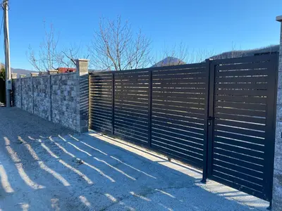 a black metal fence in front of a house at Villa Una Residence in Bihać
