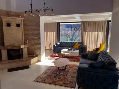 a living room with two couches and a fireplace at Villa Una Residence in Bihać