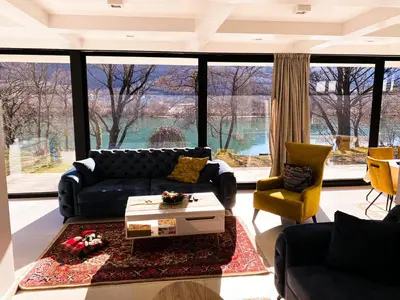 a living room with a couch and a table at Villa Una Residence in Bihać
