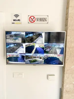 a tv on a wall with a no smoking sign at Villa Una Residence in Bihać