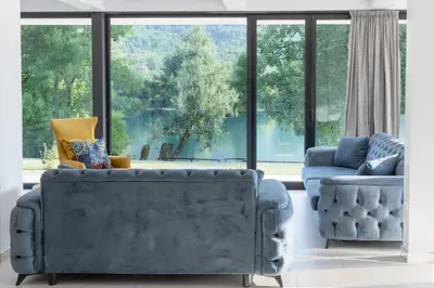 a living room with two couches and a large window at Villa Una Residence in Bihać