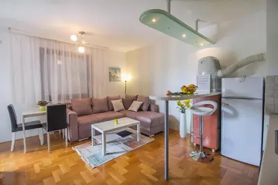 a living room with a couch and a table at Stan na Dan Banja Luka in Banja Luka