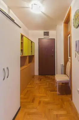 a hallway with a wooden floor and a door at Stan na Dan Banja Luka in Banja Luka