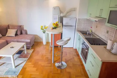 a small kitchen with a couch and a table at Stan na Dan Banja Luka in Banja Luka