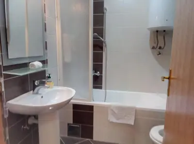 a bathroom with a sink and a toilet and a shower at Stan na Dan Banja Luka in Banja Luka