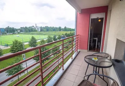 a balcony with a table and a view of a field at Stan na Dan Banja Luka in Banja Luka