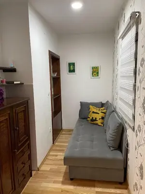 a small living room with a couch and a window at Holiday Home Ajaz Bihac in Bihać