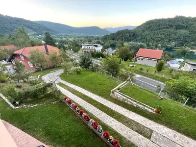 arial view of a village with a road and flowers at Holiday Home Ajaz Bihac in Bihać