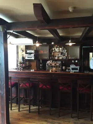 a bar in a restaurant with red bar stools at Hotel Stari grad in Jajce